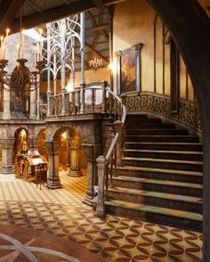 the inside of a building with stairs and chandeliers