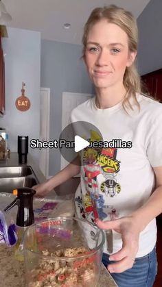 a woman standing in front of a counter with food