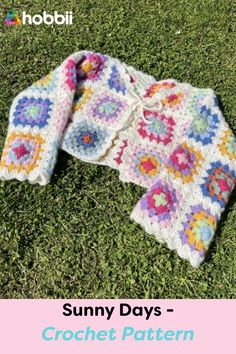 a crocheted jacket laying on the grass with text that reads sunny days crochet pattern