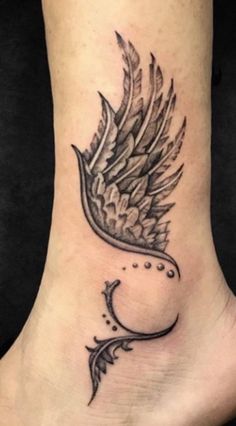 a foot with a bird tattoo on it's side and an arrow in the middle