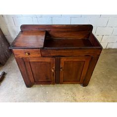 an old wooden cabinet sitting on the floor