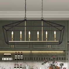 a kitchen with green cabinets and a chandelier hanging from the ceiling above it