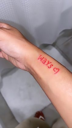 a person's arm with a red ink tattoo that says max 5 on it