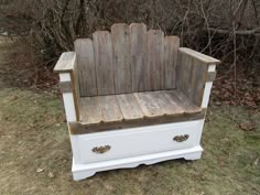 an old wooden bench sitting in the grass