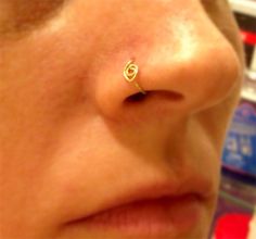 a woman's nose with a small gold ring on it