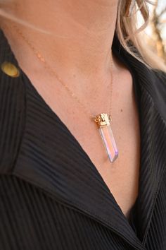 The magical Angel Aura Quartz in a point necklace! This beauty shines and glows without even trying. The rainbow aura is truly beautiful and will be an eye-catcher to all who see you. Angel Aura Quartz is the stone of good vibes. Like a rainbow in the sky, wear this timeless crystal necklace and repeat this mantra to yourself: I Am Limitless. Angel Aura Quartz crystal pendant with gold detailing 14k gold fill cable or satellite chain Handmade in Arizona Please use the size guide below to confirm Iridescent Pendant Crystal Necklace For Healing, Iridescent Crystal Gemstone Necklaces For Spiritual Use, Spiritual Iridescent Crystal Necklace With Gemstone, Iridescent Gemstone Crystal Necklace For Spiritual Use, Iridescent Crystal Necklaces For Healing, Iridescent Spiritual Gemstone Crystal Necklace, Iridescent Gemstone Necklace For Healing, Magical Healing Gemstone Crystal Necklace, Gold Mystical Crystal Necklace For Meditation