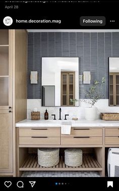 a bathroom with two sinks and large mirrors