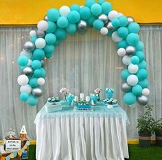 a table set up with balloons and desserts