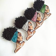 three african women with different colored hair on their heads