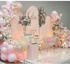 a table with balloons and flowers on it