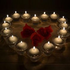 many candles are arranged in the shape of a heart