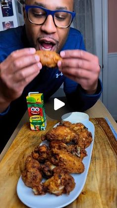 a man is eating some fried food on a plate