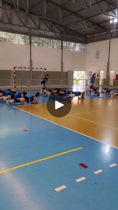 a group of people on a court playing volleyball