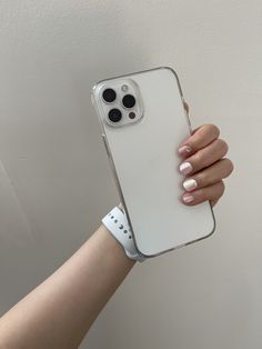 a woman's hand holding an iphone case