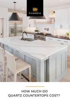 a white kitchen with an island counter top and two stools in front of it