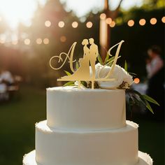 a wedding cake with the bride and groom topper on it's white frosting