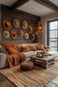 a living room filled with lots of furniture and hats on the wall above it's couch