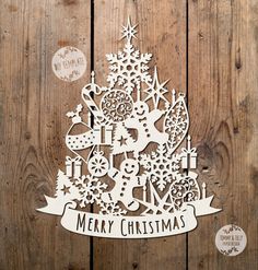 a christmas tree cutout on top of a wooden wall with the words merry christmas