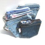 four pairs of blue jeans with zippers are sitting in a row on a white surface