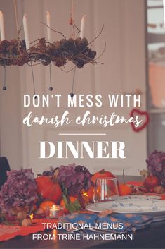 a dinner table with candles and flowers on it that says, don't mess with danish christmas dinner traditional menus from trine hahnmainn