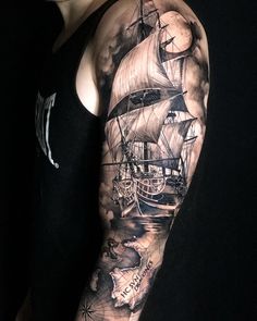 a man's arm with a ship on it