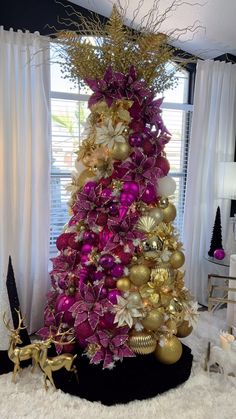 a purple and gold christmas tree in a living room