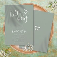 two gray cards with hearts and baby's breath written on them are sitting on a plate