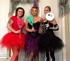 three women dressed in costumes posing for the camera