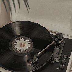 an old - fashioned record player with a flower on it