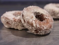 three glazed donuts sitting on top of a counter