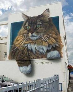 a large cat painted on the side of a building