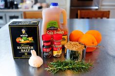 an assortment of ingredients on a table including oranges, spices and seasoning fluid