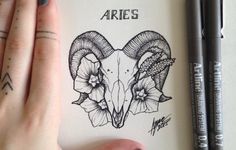 a drawing of an aries ram's head with flowers on it