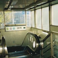 an escalator in a subway station with the door open