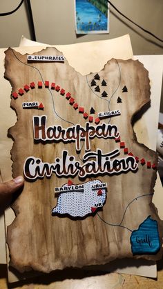 a person holding up a piece of wood with the words harafpam, cirilation on it