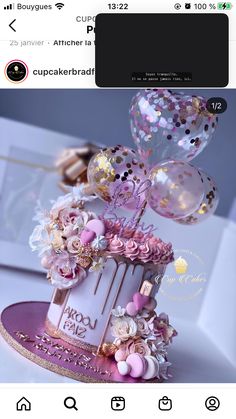 the cake is decorated with pink and gold flowers, balloons and confetti on top