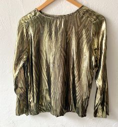 80s gold lamé top with cute woven pattern. Ever so slightly sheer in the light. Material is very nice high quality. No tags but excellent construction. Cute raglan-like seams at the armholes.  Best on an Xs - Small, bust 37" length 23"  Shown here on a small mannequin with bust 34" waist 24" hip 34" Small Mannequin, Womens Blouses, Gold Lame, Woven Pattern, Small Bust, Womens Clothing Tops, Blouses For Women, Bathing Beauties, Tops & Tees