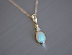 This ones a beauty! Gorgeous ethiopian opal is set in 14k gold with a diamond accent. This dainty pendant is great for when you want to dress up and is a great choice for anyone who appreciates handcrafted design and genuine gemstones. Metal : 14kt Gold Size : 17x6mm Gemstones : Ethiopian Opal, Diamond Moonstones Rainbow Moonstone acts as a prism, diffusing energy throughout the aura. It is said to provide psychic protection, clearing the mind and senses, and aids in lucid dreaming and calm slee Elegant Ethiopian Opal Jewelry With Gemstone Accents, Elegant Ethiopian Opal Gemstone Jewelry, Elegant Ethiopian Opal Necklace In Yellow Gold, Fine Jewelry With Ethiopian Opal For Formal Occasions, Fine Jewelry Ethiopian Opal For Formal Occasions, Ethiopian Opal Fine Jewelry For Formal Occasions, Formal Fine Jewelry With Ethiopian Opal, Elegant Ethiopian Opal Jewelry, Formal Opal Jewelry With Diamond Accents