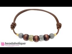 a brown leather bracelet with silver and gold beads