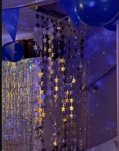 some balloons and stars hanging from the ceiling