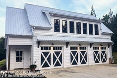 a large white house with two garage doors