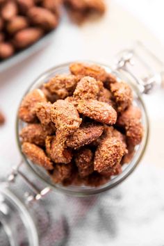 a glass bowl filled with nuts on top of a table