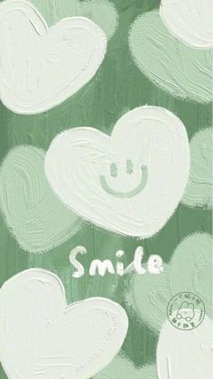 the words smile written in white and green paint on a background of hearts with faces