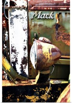 an old rusted out truck with the word mack on it's front end