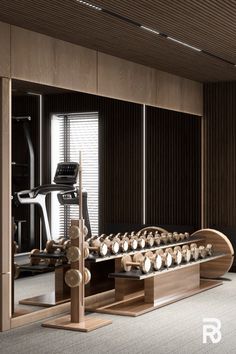 an exercise room with treadmills, machines and other equipment in it's center