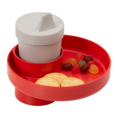 a red tray with cookies, jelly beans and a cup on it