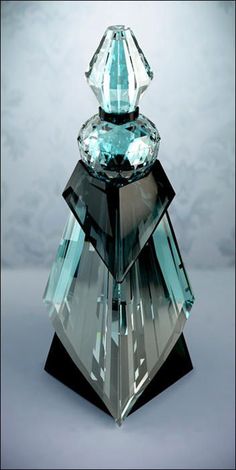 an unusual looking blue crystal object on a gray background