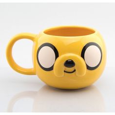 a yellow mug with a face drawn on it