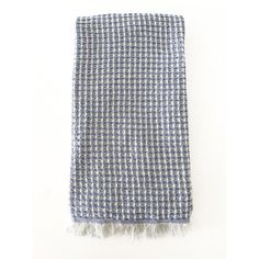 a blue and white checkered blanket with fringes on it's end, against a white background