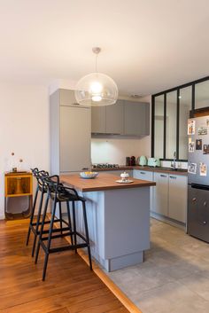 a modern kitchen with stainless steel appliances and wood flooring